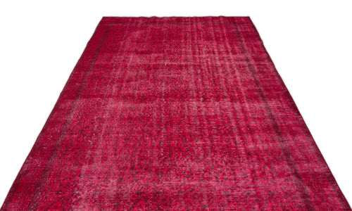 Load image 1 in gallery view. Deep red vintage-style rug with a distressed, faded traditional medallion pattern on a white background.