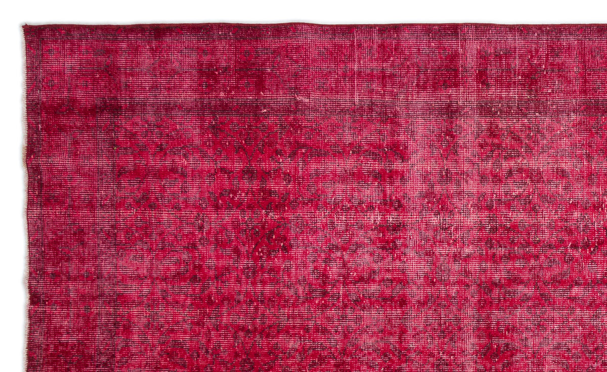 Deep magenta vintage-style rug with a distressed, faded traditional medallion pattern.