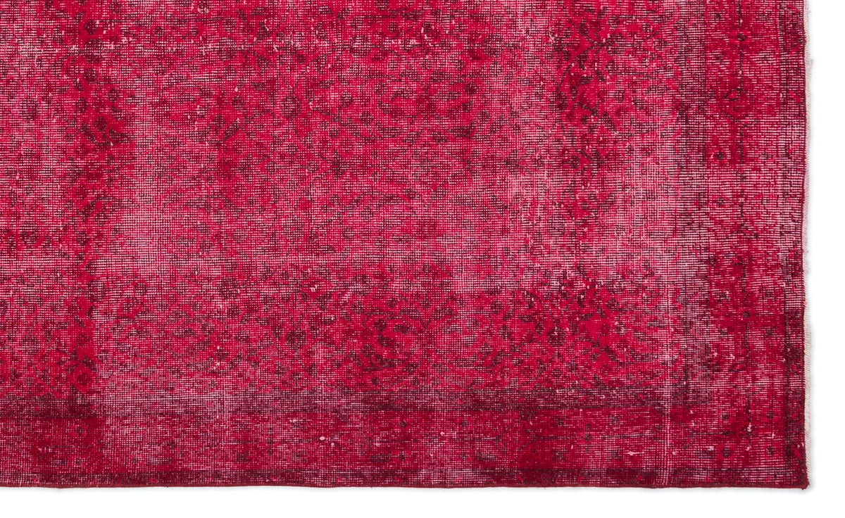 Vibrant red distressed rug with a faded traditional floral medallion pattern and a dark border.