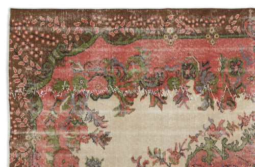 Load image 1 in gallery view. Distressed vintage rug fragment with a floral medallion pattern in brown, coral, and sage green on a cream background.