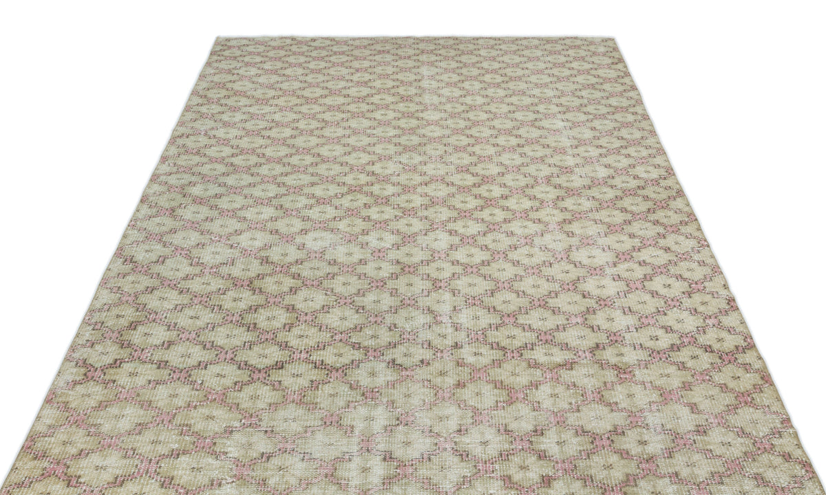 Beige and pink distressed rug with a repeating geometric diamond lattice pattern on a white background.