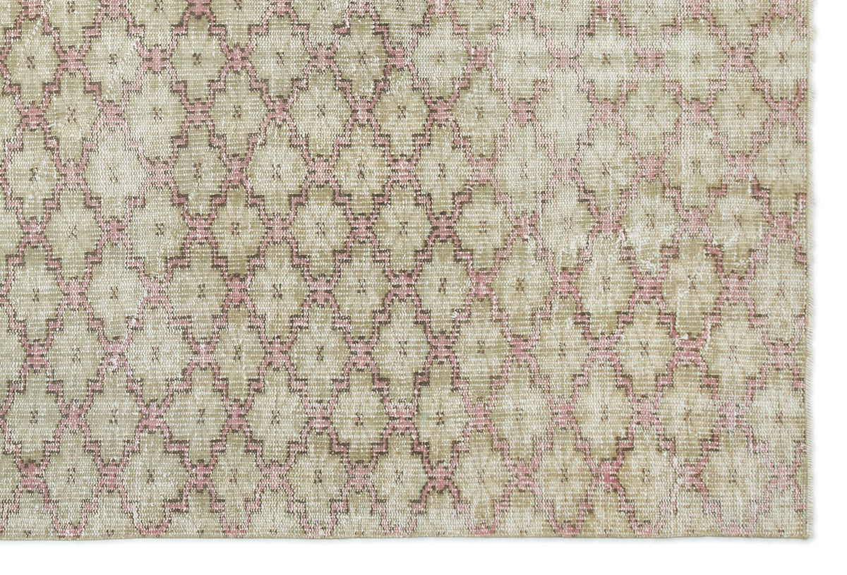 Beige and pink distressed rug with a repeating geometric diamond lattice pattern.