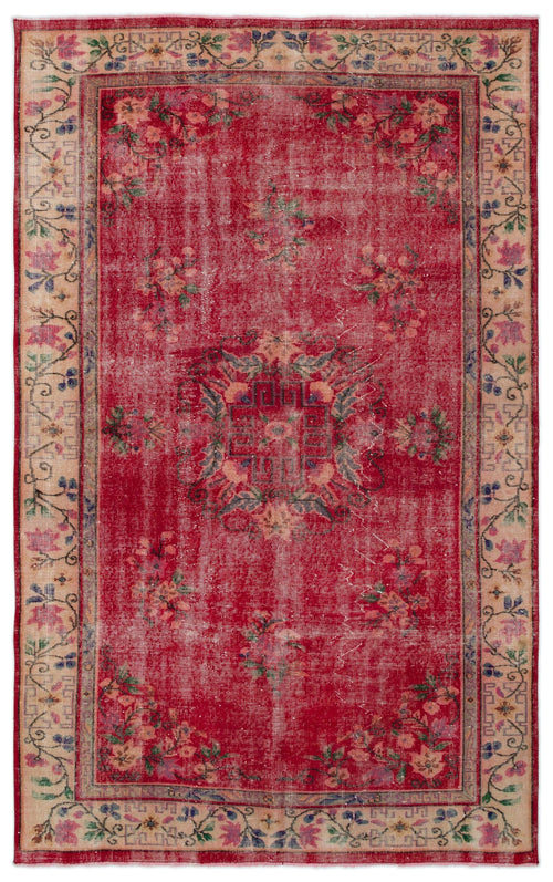 Load image 1 in gallery view. Distressed red vintage rug with a central geometric medallion, floral motifs, and a beige border.