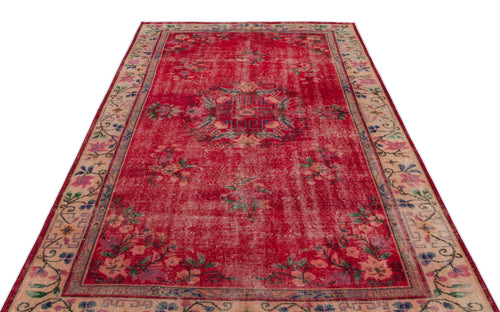 Load image 1 in gallery view. Distressed red vintage rug with a central floral medallion and a beige floral border on a white background.