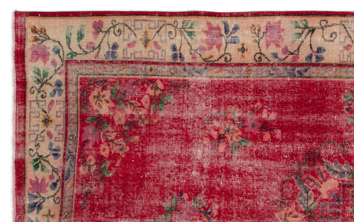 Load image 1 in gallery view. Distressed red rug with a floral pattern and a beige border featuring geometric and botanical motifs.