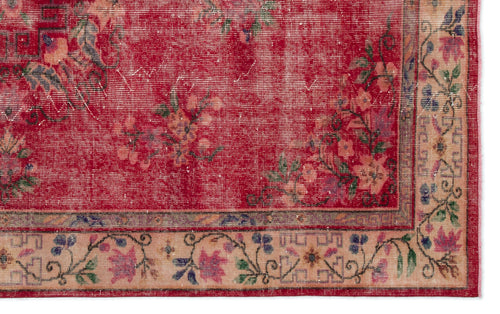 Load image 1 in gallery view. Distressed red rug with a floral pattern and a beige border featuring geometric and botanical motifs.