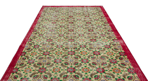 Load image 1 in gallery view. Beige rug with a red border and a repeating floral medallion pattern in red, green, and blue on a white background.