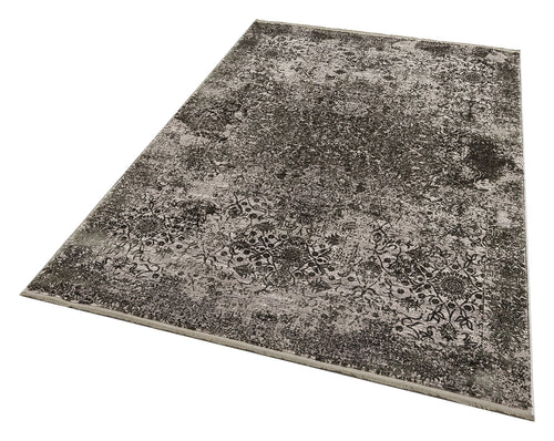 Load image 1 in gallery view. Charcoal and grey distressed rug with a faded traditional floral medallion pattern on a white background.