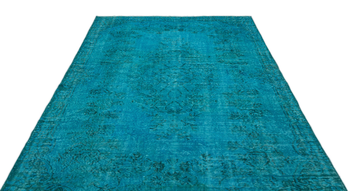 Teal distressed vintage-style rug with a faded traditional floral medallion pattern on a white background.