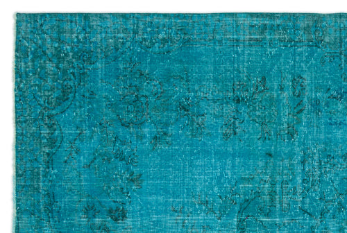 Load image 1 in gallery view. Teal vintage-style rug with a distressed, faded floral pattern and dark blue line details.
