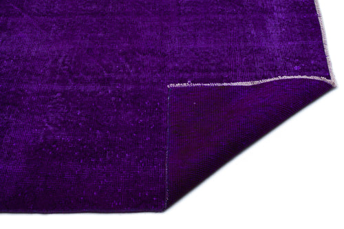 Load image 1 in gallery view. Deep purple distressed-style rug with a folded corner revealing the woven backing on a white background.