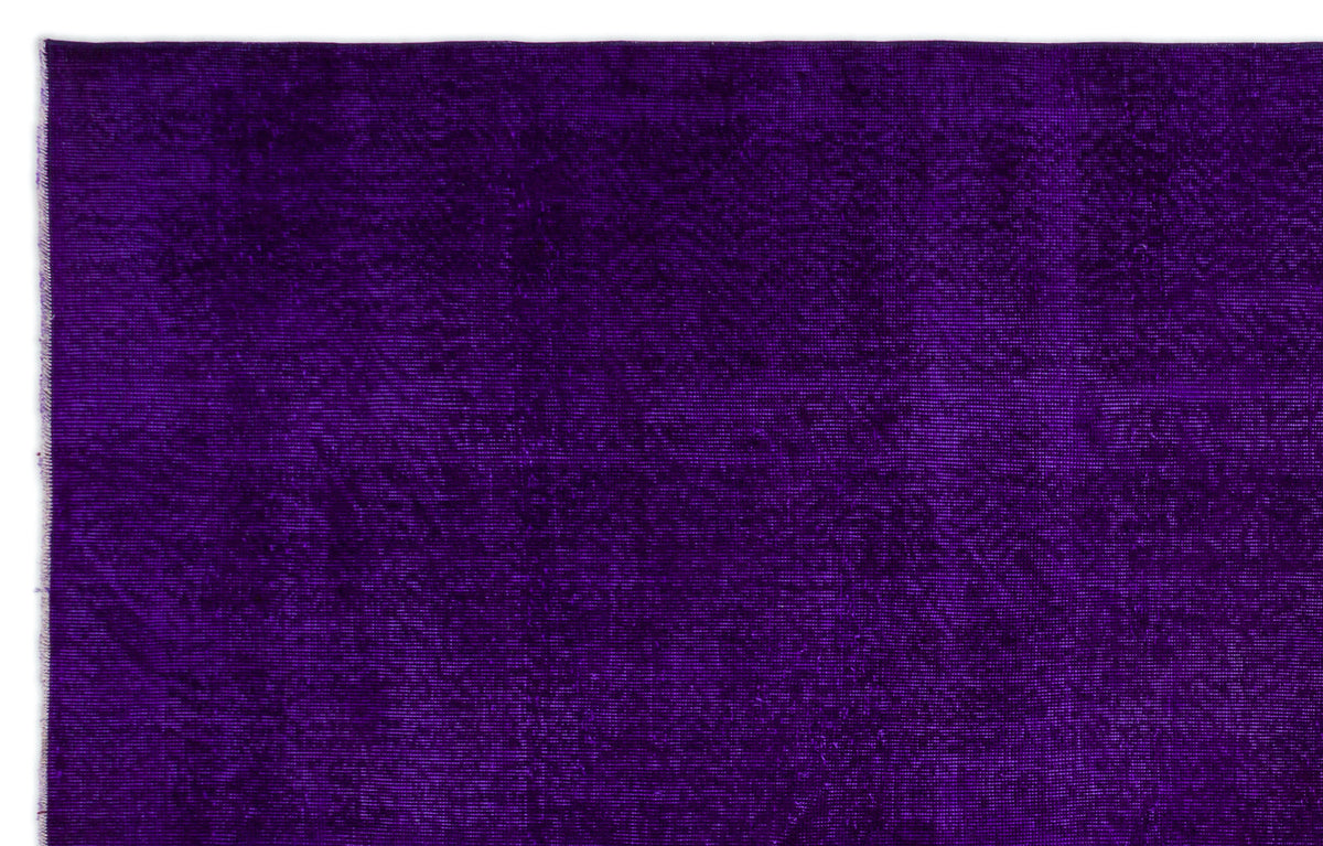 Solid deep purple rug with a subtle, distressed texture on a white background.