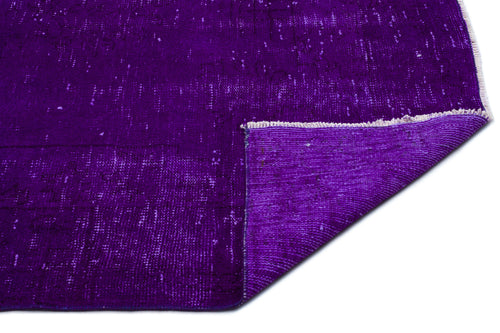 Load image 1 in gallery view. Deep purple distressed rug with a folded corner revealing the textured underside and white fringe.