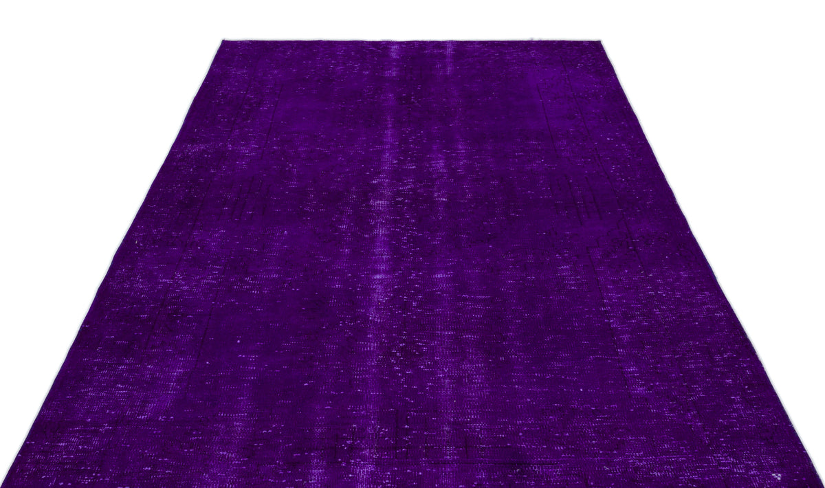 Deep purple vintage-style rug with a distressed, overdyed texture and faint traditional medallion pattern.