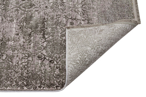 Load image 1 in gallery view. Taupe and grey distressed floral rug with a corner folded over to reveal the woven backing.