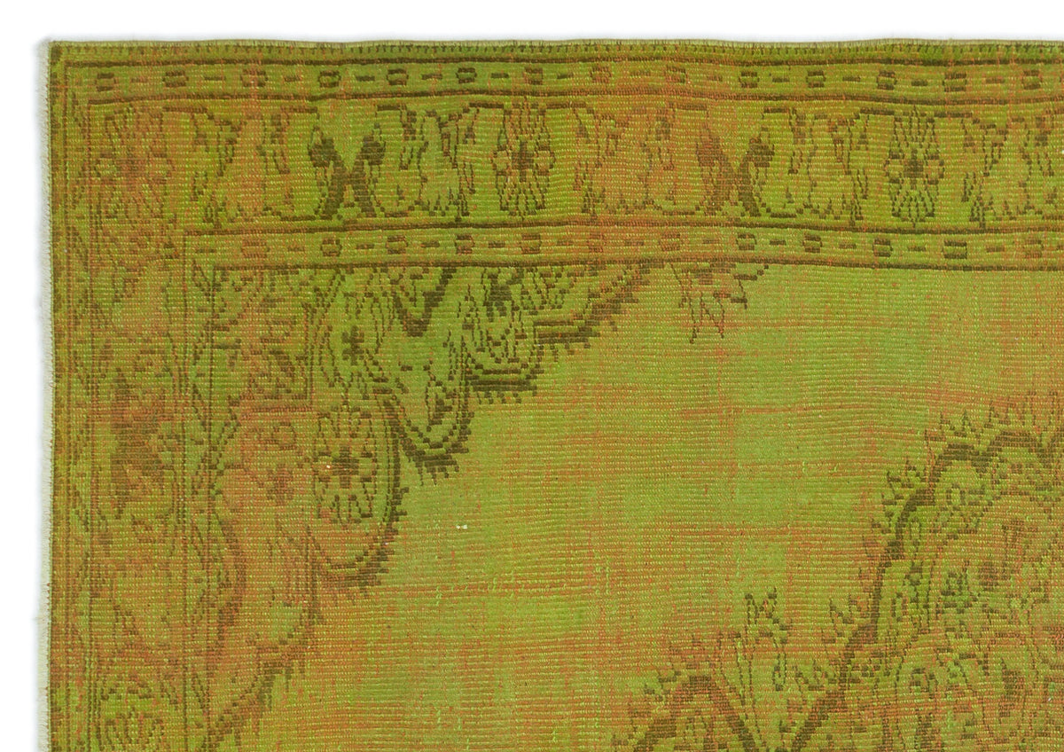 Chartreuse and olive green vintage-style rug with a distressed traditional floral medallion border.