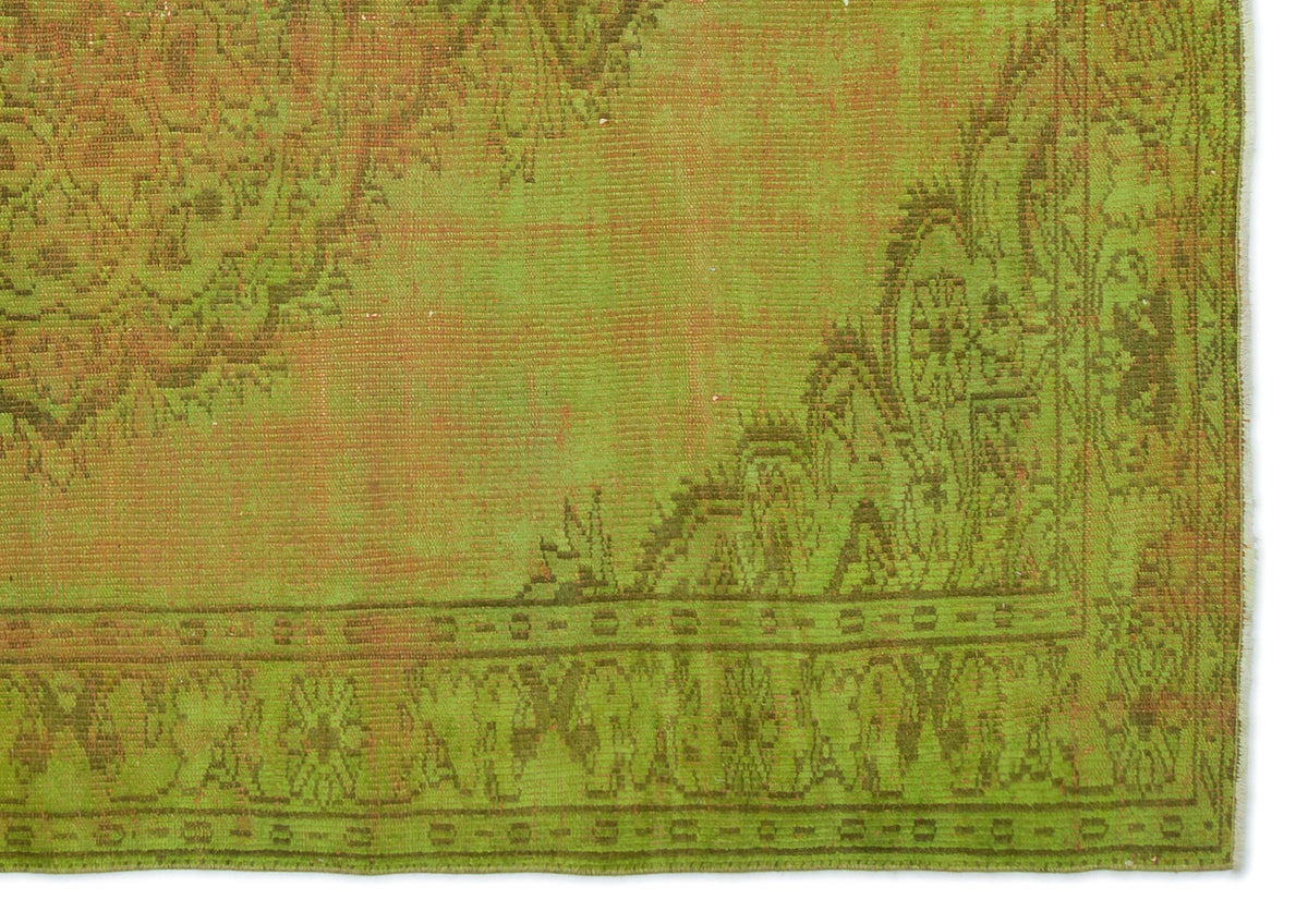 Chartreuse and olive green vintage-style rug with a distressed traditional medallion and border pattern.