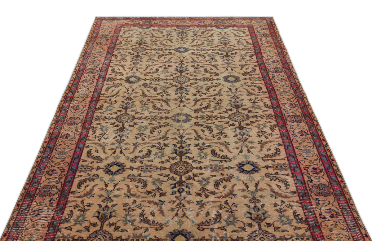 Beige traditional rug with a red border and intricate floral medallion pattern in blue and brown tones.