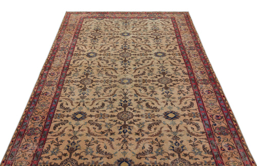 Load image 1 in gallery view. Beige traditional rug with a red border and intricate floral medallion pattern in blue and brown tones.