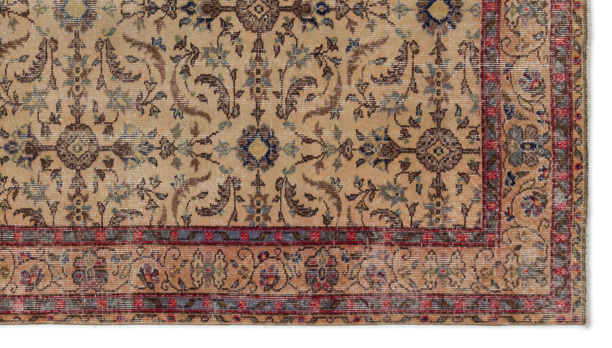 Beige traditional rug with a distressed floral medallion pattern, accented by blue and red borders.