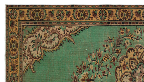 Load image 1 in gallery view. Green traditional rug with a tan floral border and intricate brown and beige paisley-style corner motifs.