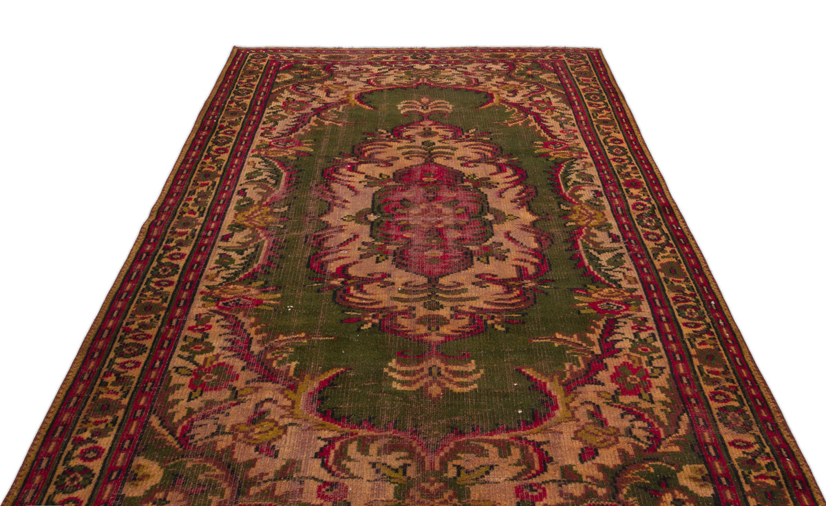 Olive green and crimson traditional rug with a central floral medallion and ornate border on a white background.