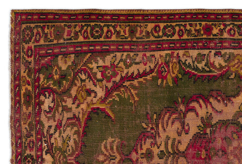 Load image 1 in gallery view. Antique rug corner with a dark green field, red border, and intricate floral medallion patterns in tan and crimson.
