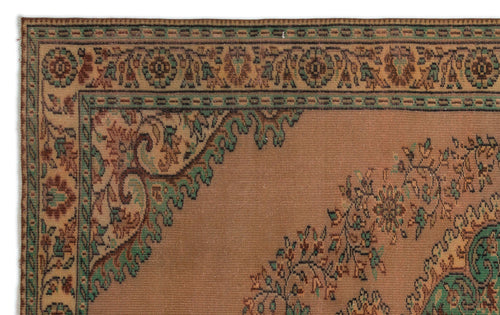Load image 1 in gallery view. Tan traditional rug with a green and brown floral border and central medallion motif.