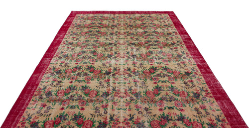 Load image 1 in gallery view. Beige rug with a distressed floral pattern in red, green, and blue, featuring a wide red border.