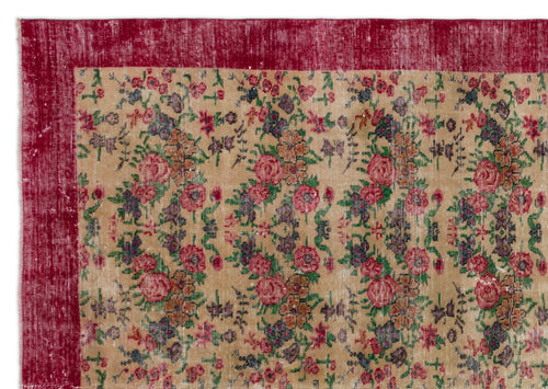 Load image 1 in gallery view. Distressed beige rug with a deep red border and a repeating floral pattern in red, green, and dark blue.
