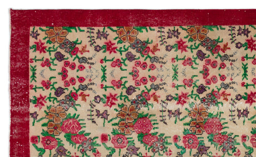 Load image 1 in gallery view. Beige rug with a red border and a repeating floral pattern in red, green, and purple on a white background.