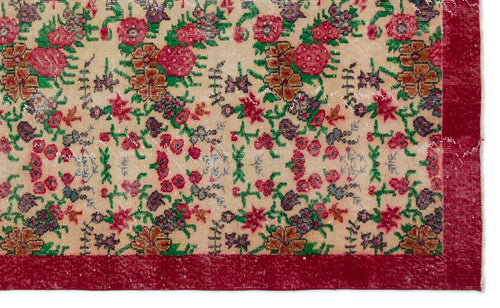 Load image 1 in gallery view. Beige rug with a distressed floral pattern in red, green, and brown, featuring a solid red border.