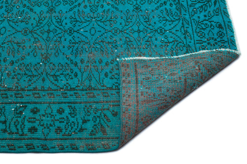 Load image 1 in gallery view. Teal and charcoal rug with a traditional floral medallion pattern, shown with a corner folded to reveal the backing.