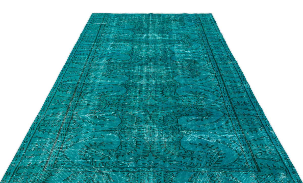 Teal distressed vintage-style rug with a faded traditional floral medallion pattern on a white background.