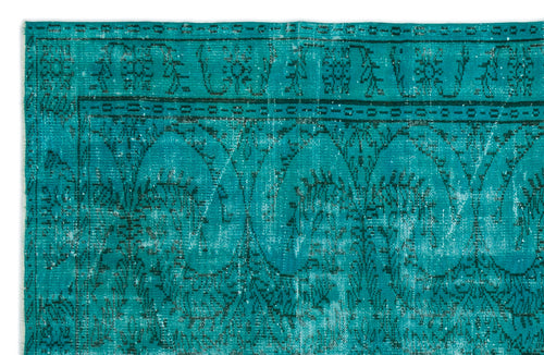Load image 1 in gallery view. Teal distressed rug with a dark green traditional floral medallion border and repeating arched pattern.