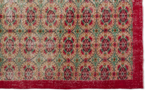 Load image 1 in gallery view. Beige rug with a repeating floral medallion pattern in red and green, featuring a solid red border.