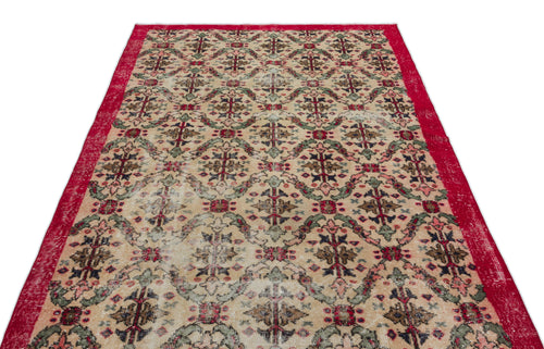 Load image 1 in gallery view. Beige vintage rug with a red border and a repeating floral medallion pattern in red, green, and dark blue.