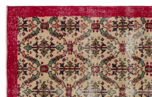 Load image 1 in gallery view. Beige vintage-style rug with a red border and a repeating floral medallion pattern in red, green, and dark brown.