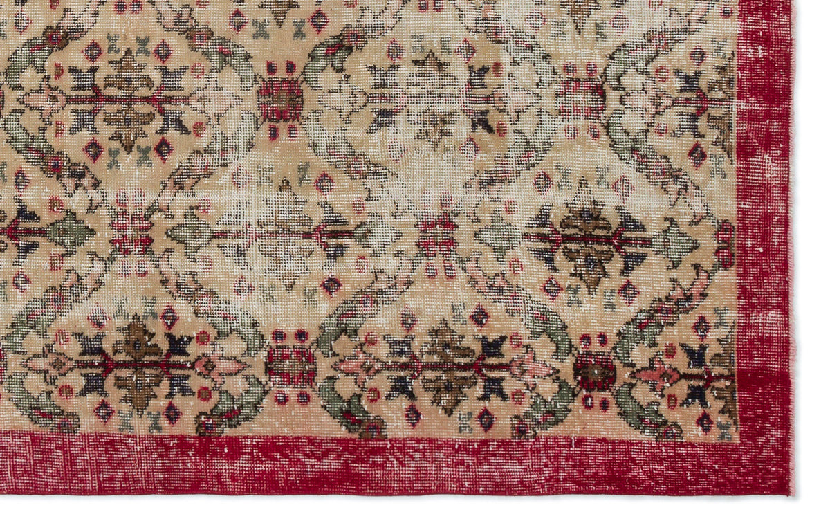Beige vintage-style rug with a distressed floral medallion pattern in red, green, and black, featuring a solid red border.