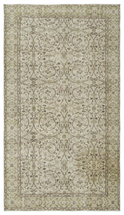 Load image 1 in gallery view. Beige and taupe vintage-style rug with a repeating circular floral medallion pattern and a decorative border.