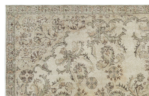 Load image 1 in gallery view. Beige and sage green traditional rug with a distressed floral medallion pattern on a white background.