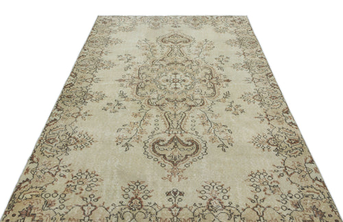 Load image 1 in gallery view. Beige and brown distressed traditional rug with a central floral medallion and ornate border pattern on a white background.