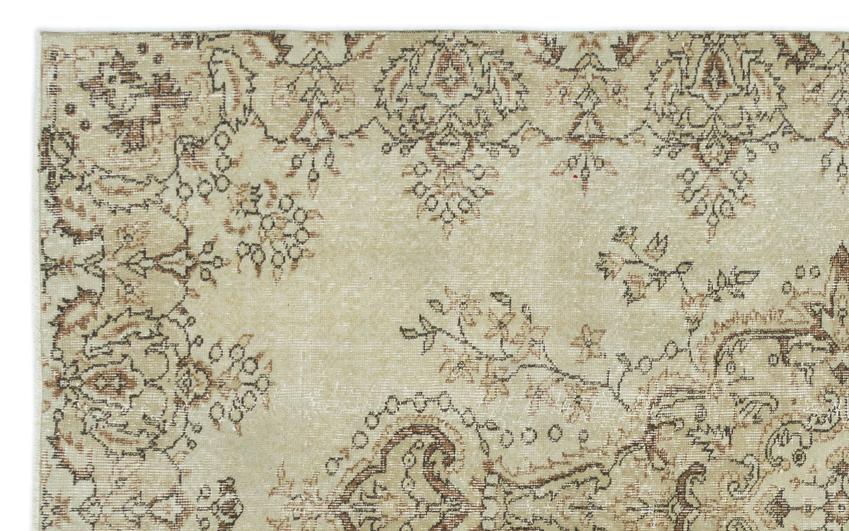 Beige and brown distressed rug with a traditional floral medallion pattern.