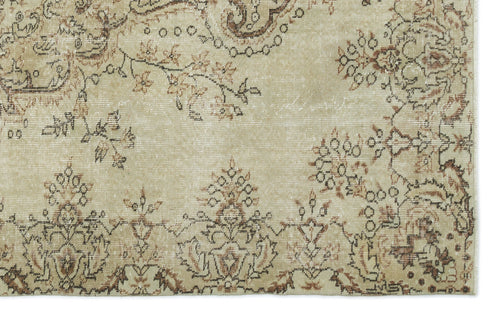Load image 1 in gallery view. Beige rug with a distressed, faded floral and paisley pattern in shades of brown and charcoal.