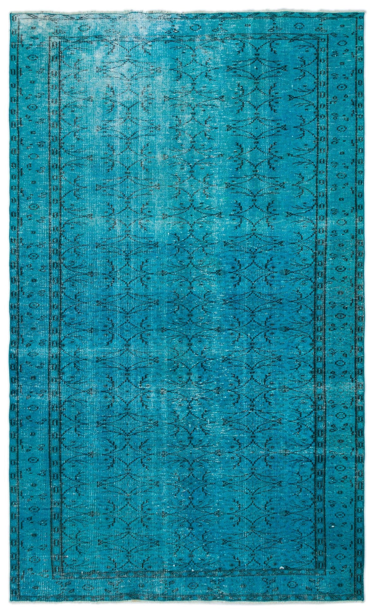 Bright turquoise distressed rug with a dark blue floral trellis pattern and a decorative border.