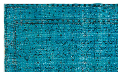 Load image 1 in gallery view. Teal rug with a distressed black geometric floral pattern and a bordered edge on a white background.
