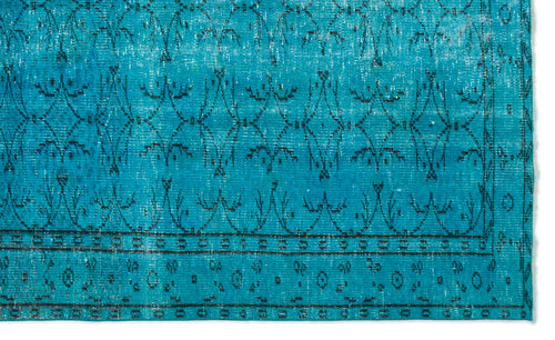 Load image 1 in gallery view. Bright turquoise rug with a distressed black geometric floral pattern and a bordered edge.