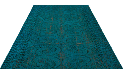 Load image 1 in gallery view. Teal distressed rug with a repeating dark floral medallion pattern and a bordered edge on a white background.