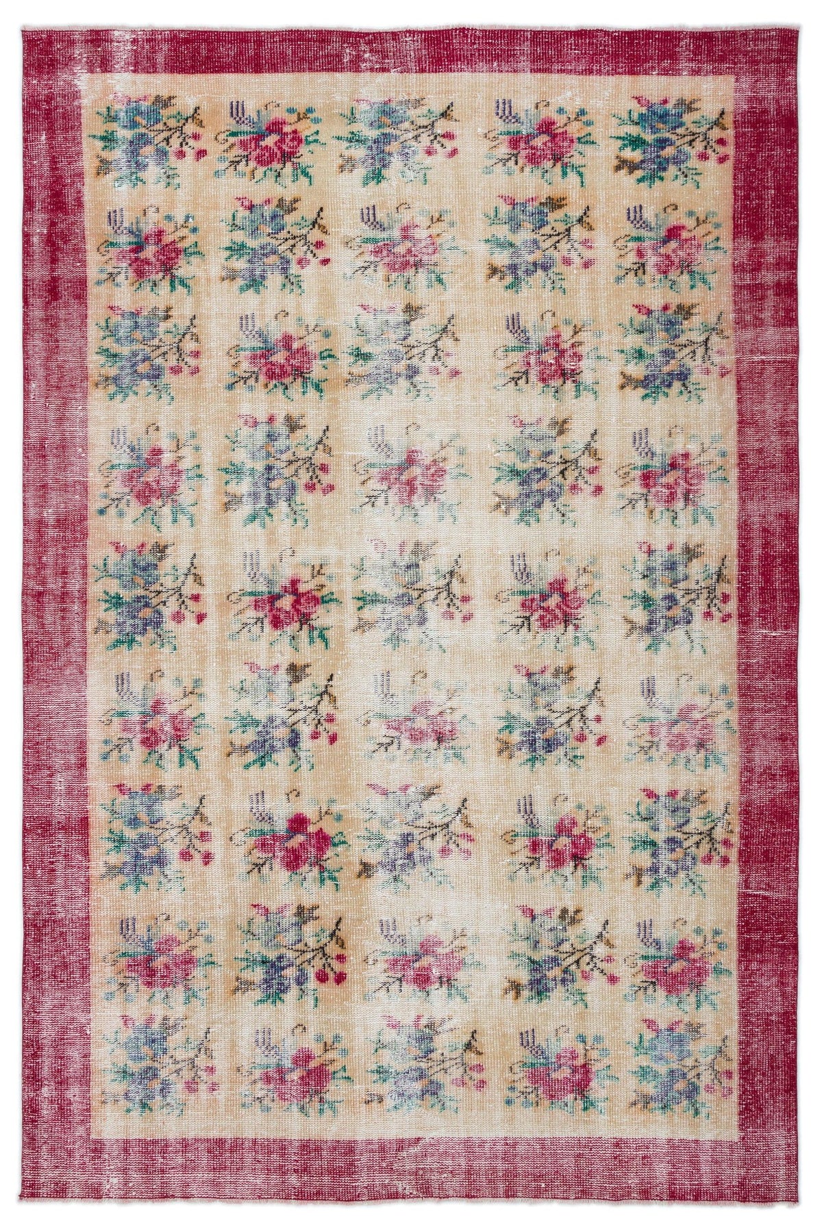 Beige vintage-style rug with a repeating floral pattern in pink, blue, and green, framed by a distressed red border.