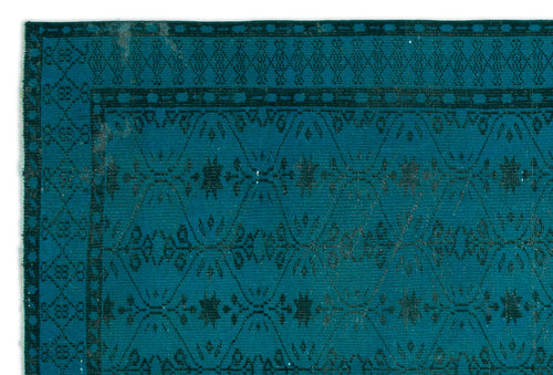 Load image 1 in gallery view. Teal rug with a dark geometric diamond lattice pattern and central floral motifs, isolated on a white background.